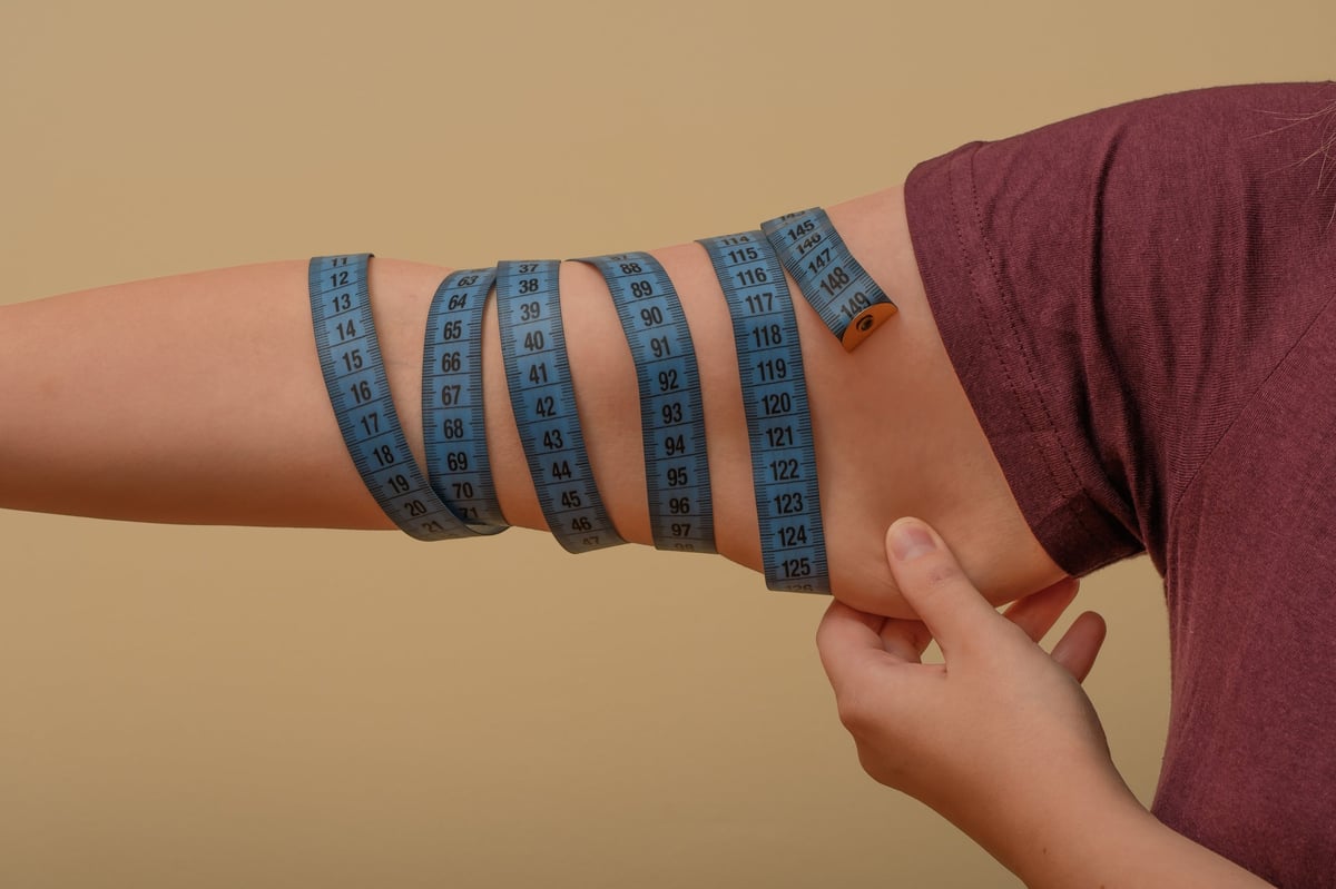 Woman's sagging arms close up isolated